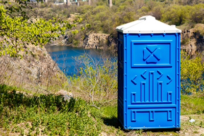 porta potty out doors near a river